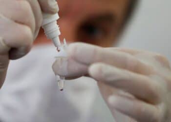 Santiago Webajh, scientist of the Pablo Cassara foundation, puts a drop of reagent in a container during a test of the new "NEOKIT-COVID-19?, developed by a group of Argentine scientists that diagnoses the coronavirus disease (COVID-19) in less than two hours, in Buenos Aires, Argentina May 19, 2020. REUTERS/Agustin Marcarian